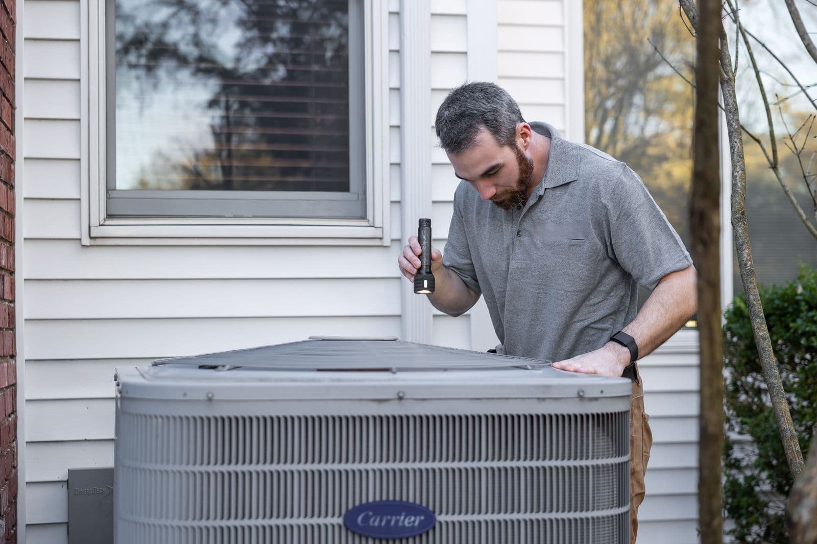 CCC technician inspecting an AC unit